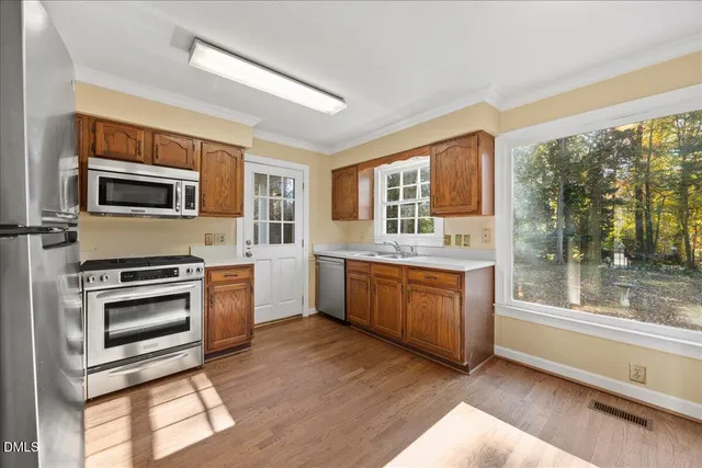 a kitchen with stainless steel appliances granite countertop a stove top oven