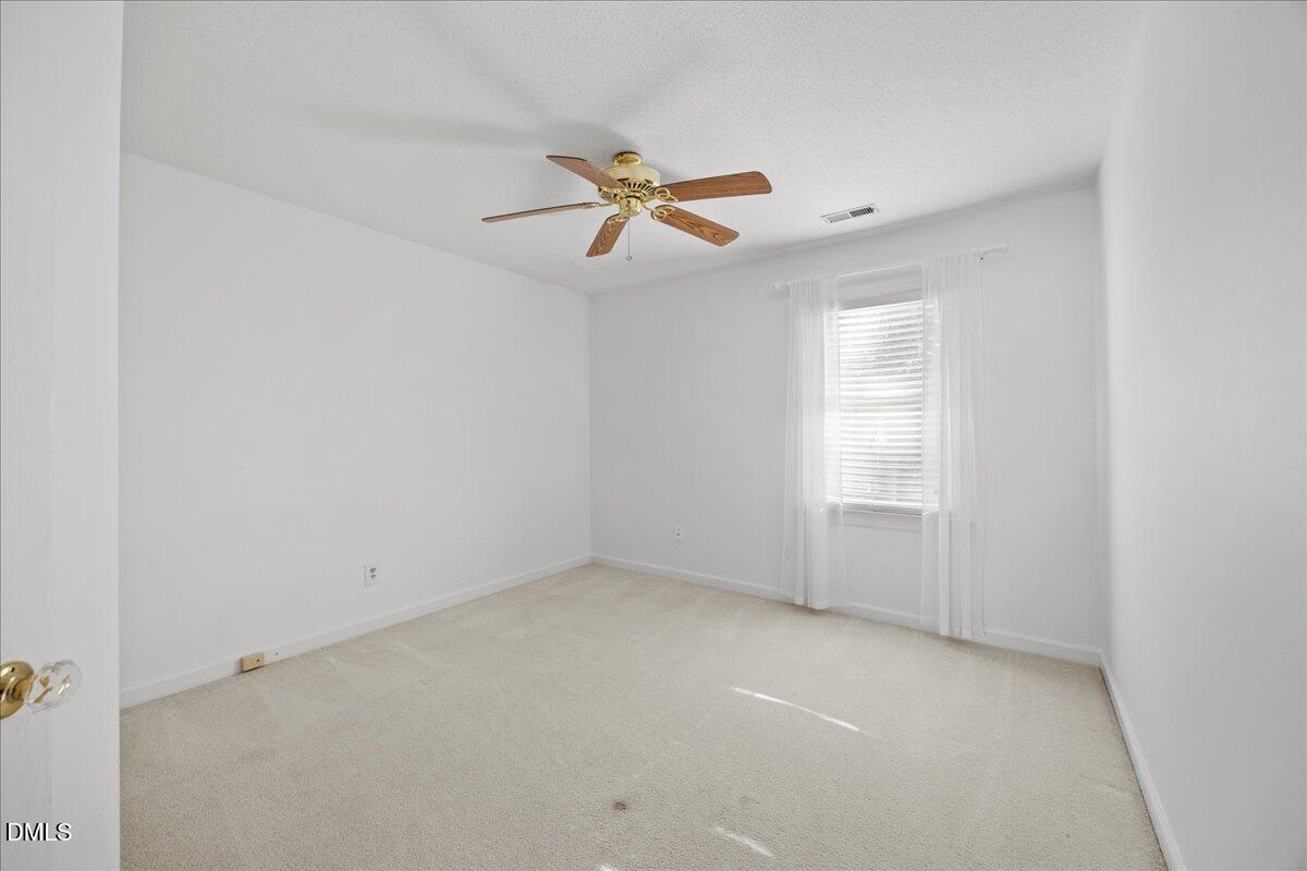 800 Temple Street Raleigh, NC 27609 - Photo 22 of 37 an empty room with windows and fan