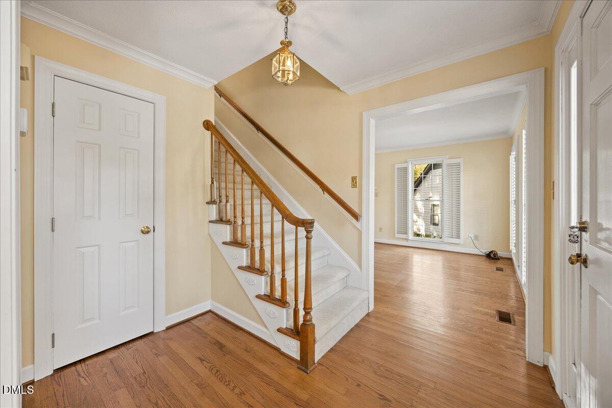 800 Temple Street Raleigh, NC 27609 - Photo 3 of 37 a view of a hallway with wooden floor and staircase