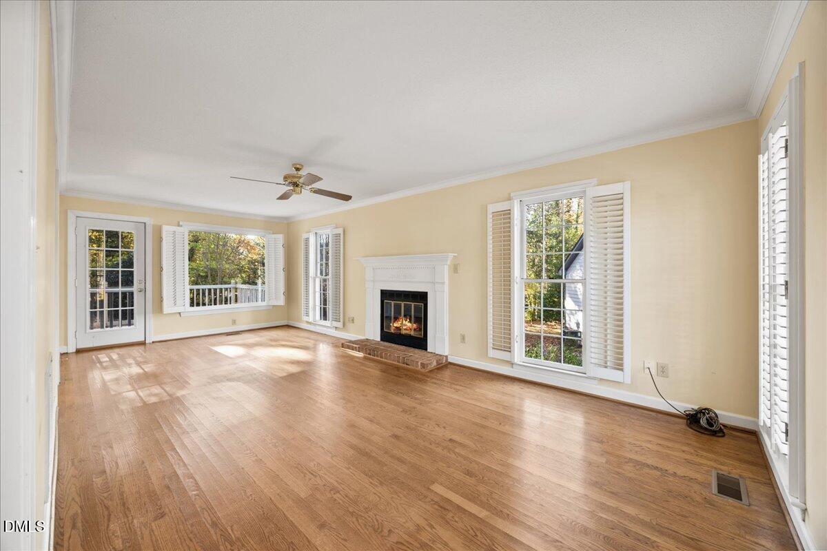 800 Temple Street Raleigh, NC 27609 - Photo 6 of 37 a view of an empty room with wooden floor and a window