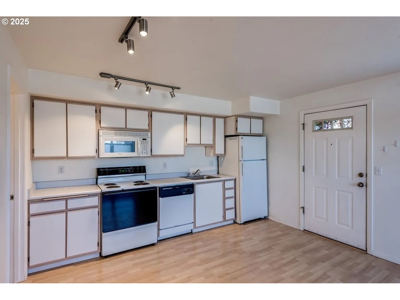 10345 Northeast Clackamas Street, Unit 15 Portland, OR 97220 - Photo 4 of 14 a kitchen with stainless steel appliances granite countertop a stove a refrigerator and a sink with wooden cabinets