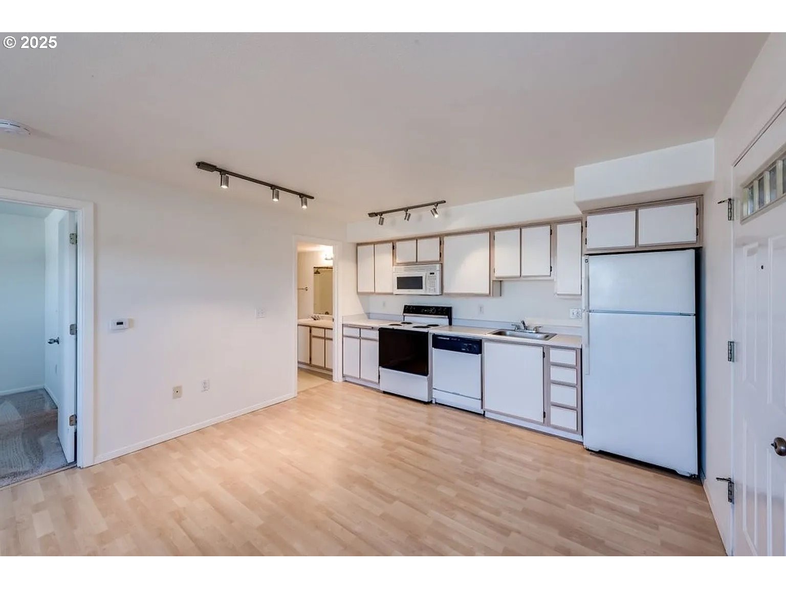 10345 Northeast Clackamas Street, Unit 15 Portland, OR 97220 - Photo 5 of 14 a kitchen with refrigerator cabinets and wooden floor