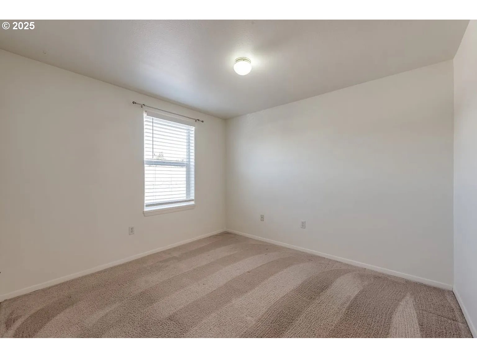10345 Northeast Clackamas Street, Unit 15 Portland, OR 97220 - Photo 8 of 14 a view of an empty room with a window