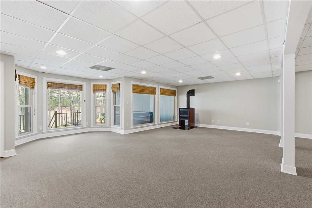 501 Capri Point Lavonia, GA 30553 - Photo 6 of 50 This expansive area features a captivating fireplace, large windows, and inviting carpeted flooring.