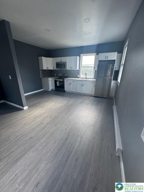 116 East Ridge Street, Unit 2 Coaldale, PA 18218 - Photo 3 of 10 an empty room with wooden floor cabinet and windows