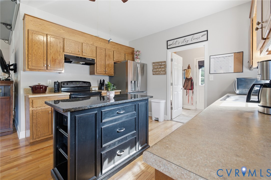9433 Robin Road Disputanta, VA 23842 - Photo 12 of 26 Kitchen featuring a central island with a dark cou