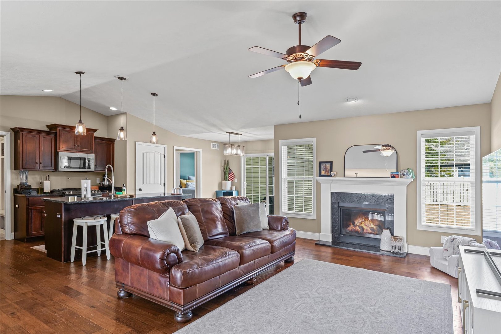 2022 Prairie Grass Lane Mahomet, IL 61853 - Photo 13 of 51 a living room with furniture a fireplace and a flat screen tv