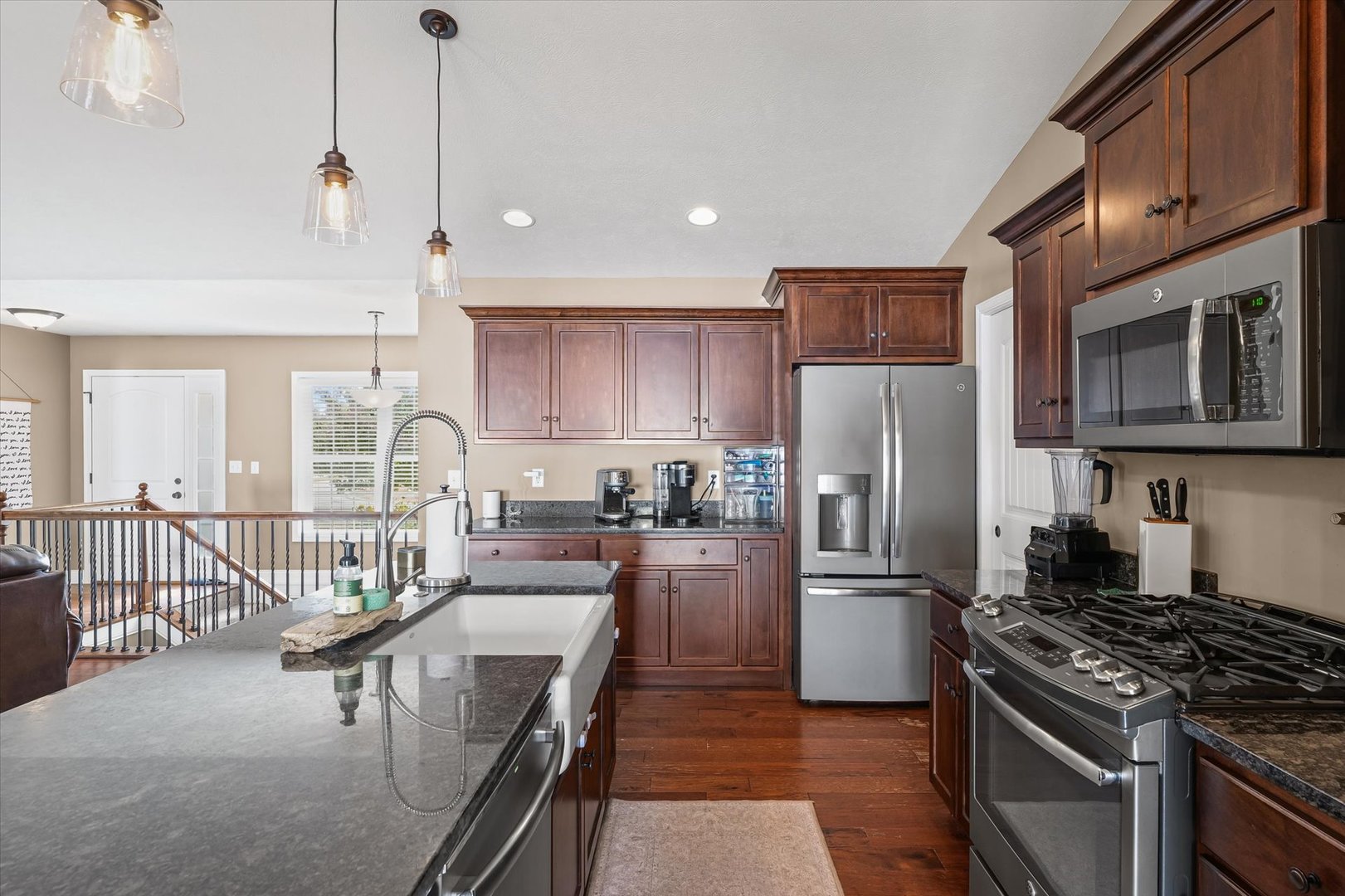 2022 Prairie Grass Lane Mahomet, IL 61853 - Photo 17 of 51 a kitchen with stainless steel appliances granite countertop a refrigerator a stove a sink a dining table and chairs with wooden floor