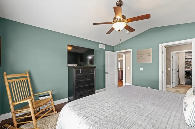 a bedroom with a bed and a television