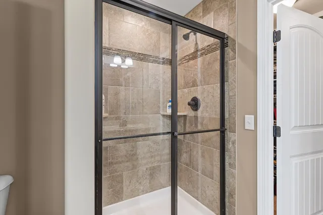 a bathroom with a glass shower door