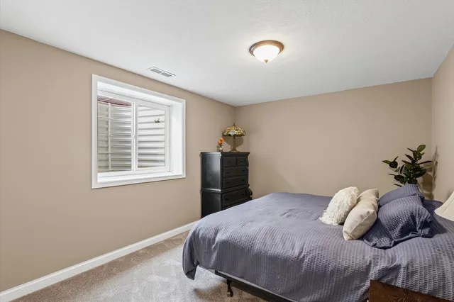 a bedroom with a bed and a potted plant