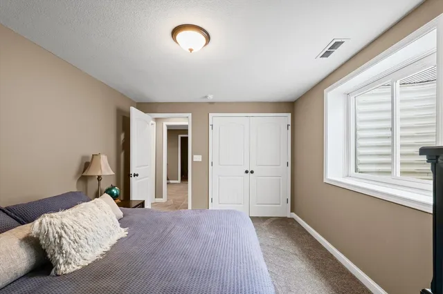 a bedroom with bed and a window