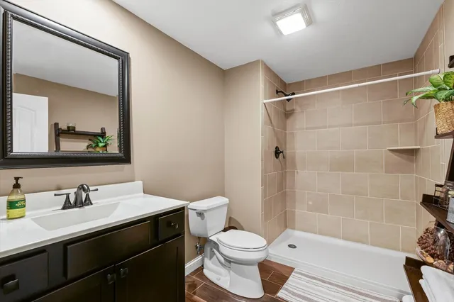 a bathroom with a sink mirror vanity and toilet