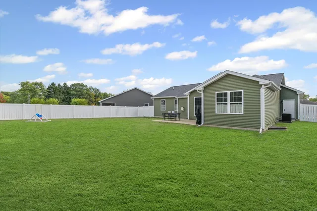 a front view of a house with yard patio and green space