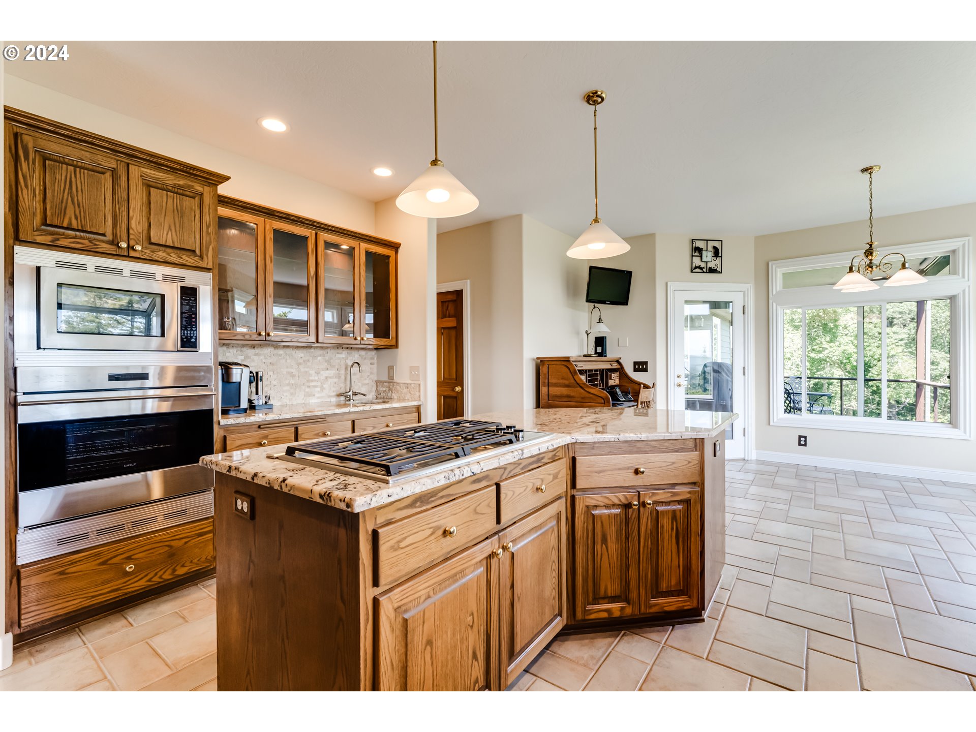 85290 Ridge Top Drive Eugene, OR 97405 - Photo 12 of 48 a kitchen with stainless steel appliances kitchen island granite countertop a stove a sink dishwasher and white cabinets with wooden floor