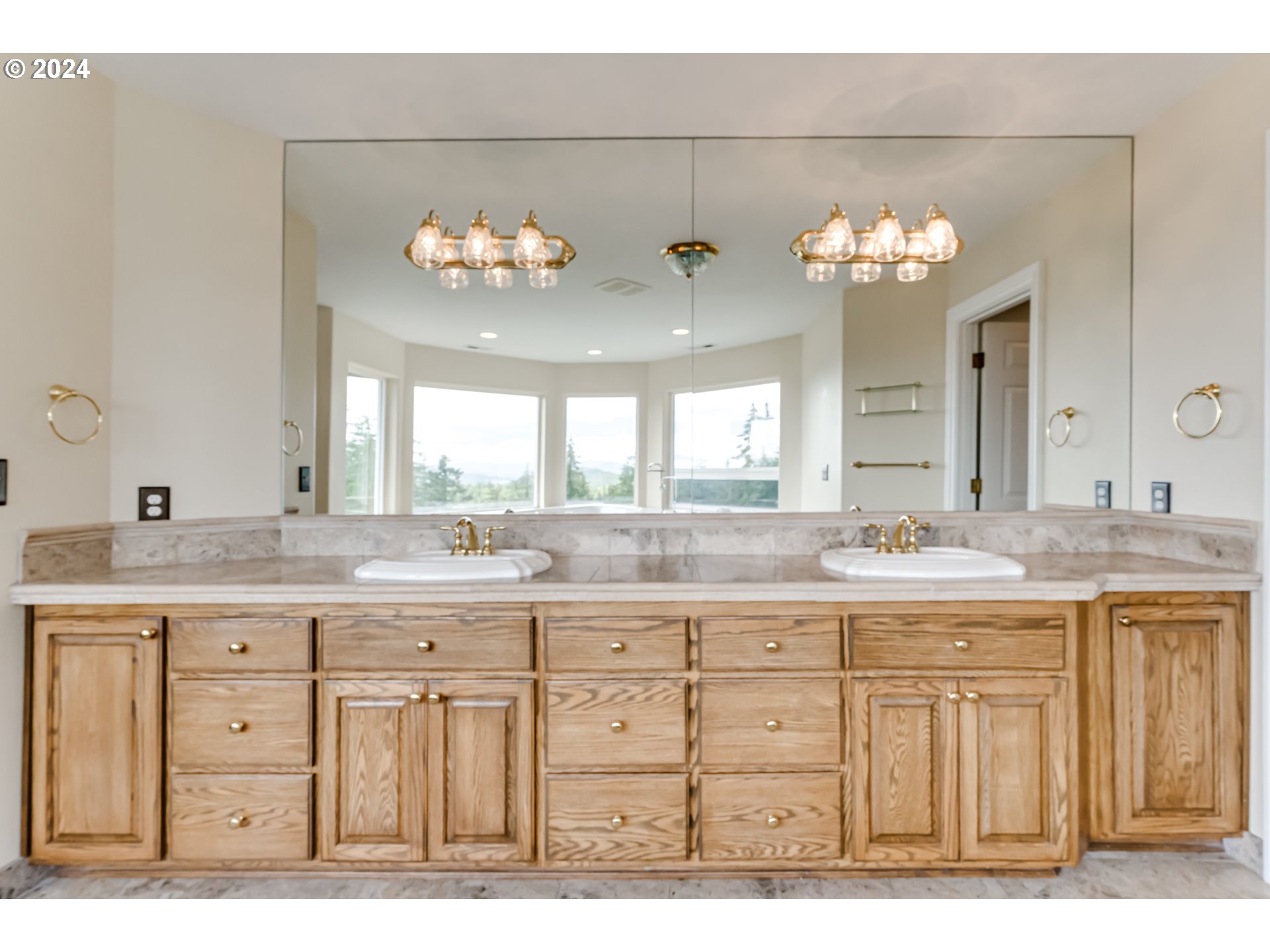 85290 Ridge Top Drive Eugene, OR 97405 - Photo 29 of 48 a bathroom with a granite countertop sink a light fixture and a window