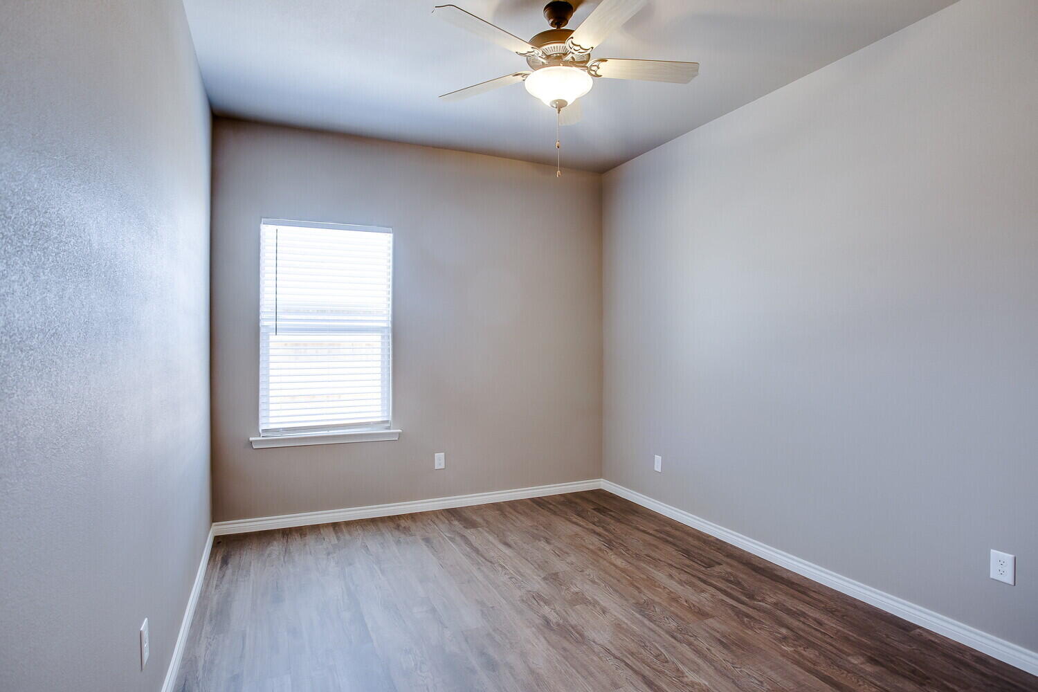 1405 16th Street, Unit A Shallowater, TX 79363 - Photo 14 of 17 an empty room with wooden floor and windows