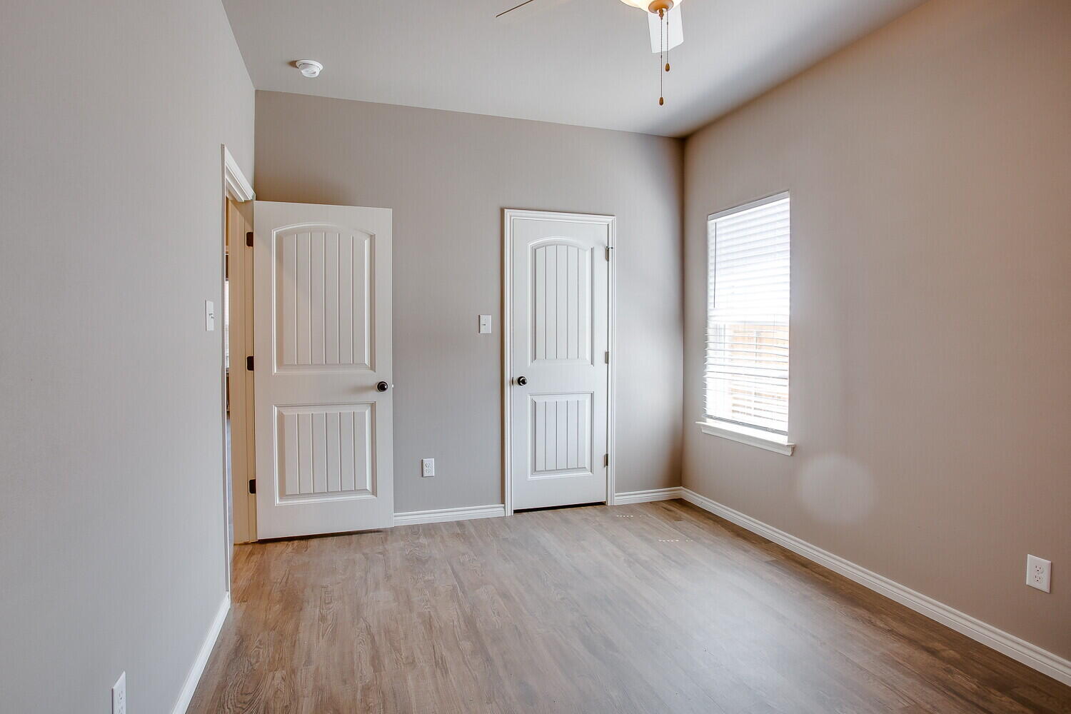 1405 16th Street, Unit A Shallowater, TX 79363 - Photo 15 of 17 an empty room with wooden floor and windows