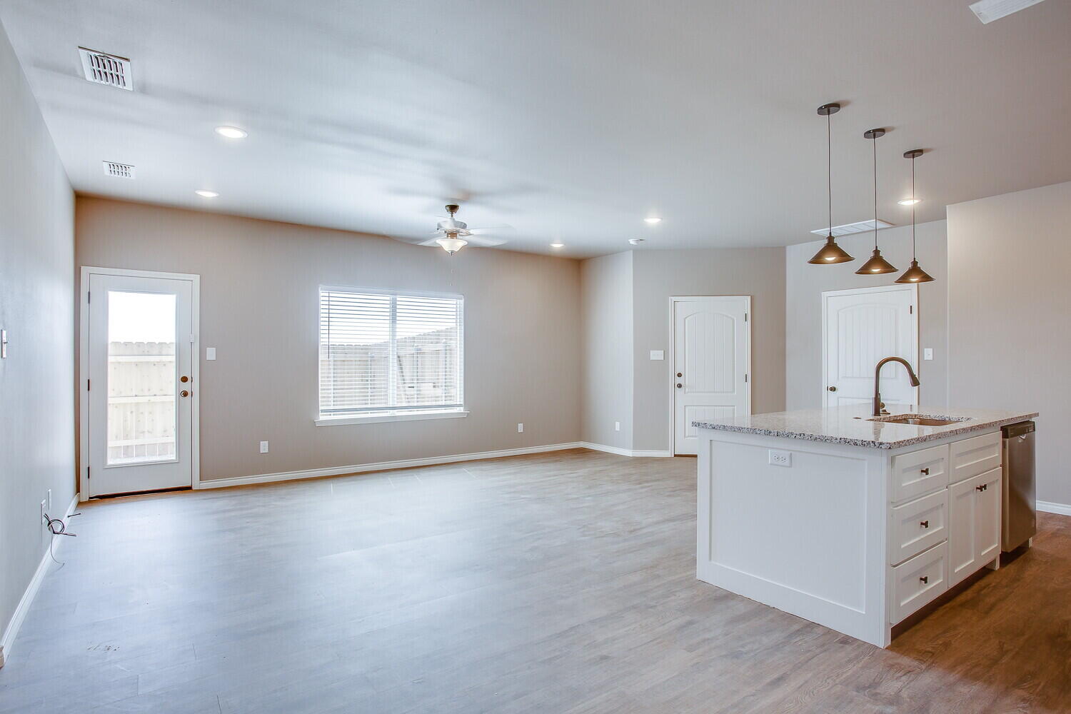 1405 16th Street, Unit A Shallowater, TX 79363 - Photo 5 of 17 a view of a kitchen with a sink hardwood floor and a large window