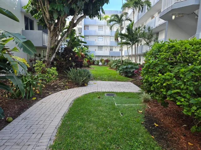 a view of a balcony with two chairs and a potted plant