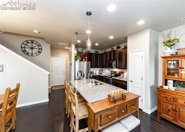a living room with furniture and kitchen view