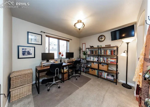 a view of a workspace with a bookshelf