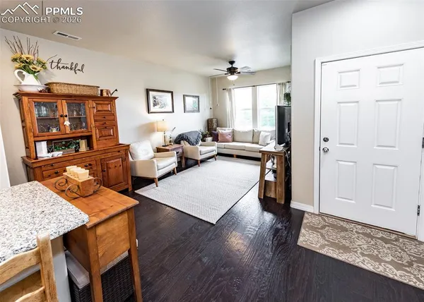 a living room with furniture and wooden floor