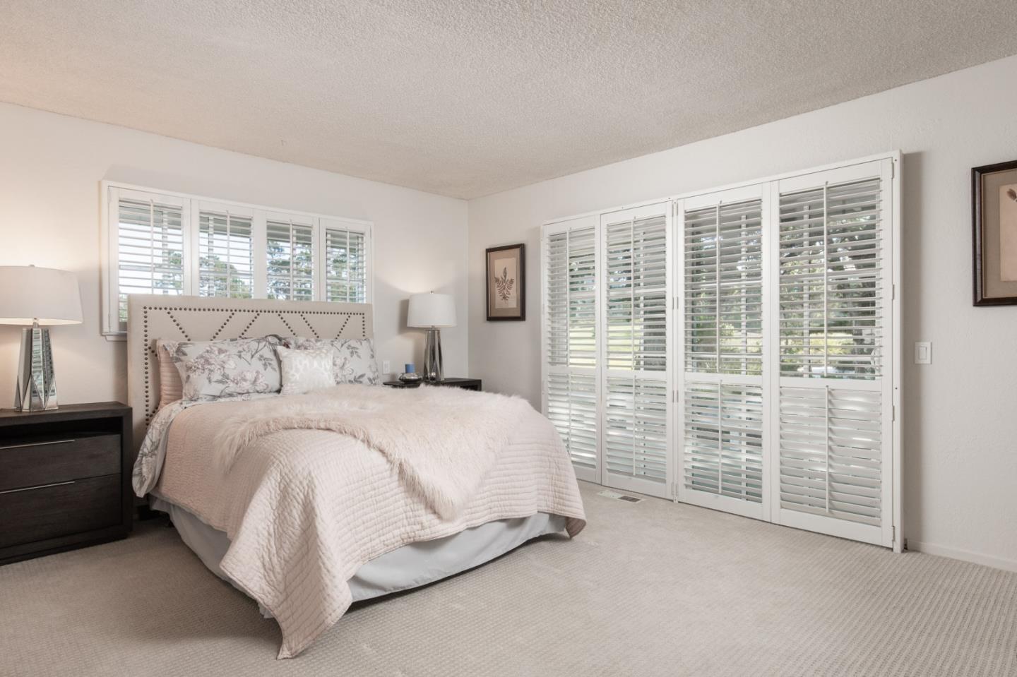 2972 Cormorant Road Pebble Beach, CA 93953 - Photo 15 of 26 a spacious bedroom with a bed and a window