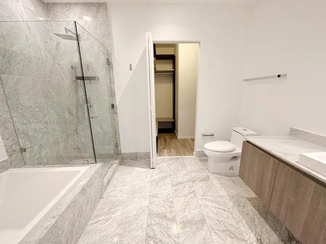 a bathroom with a bathtub and a shower