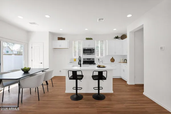 a kitchen with a sink a stove cabinets and counter space