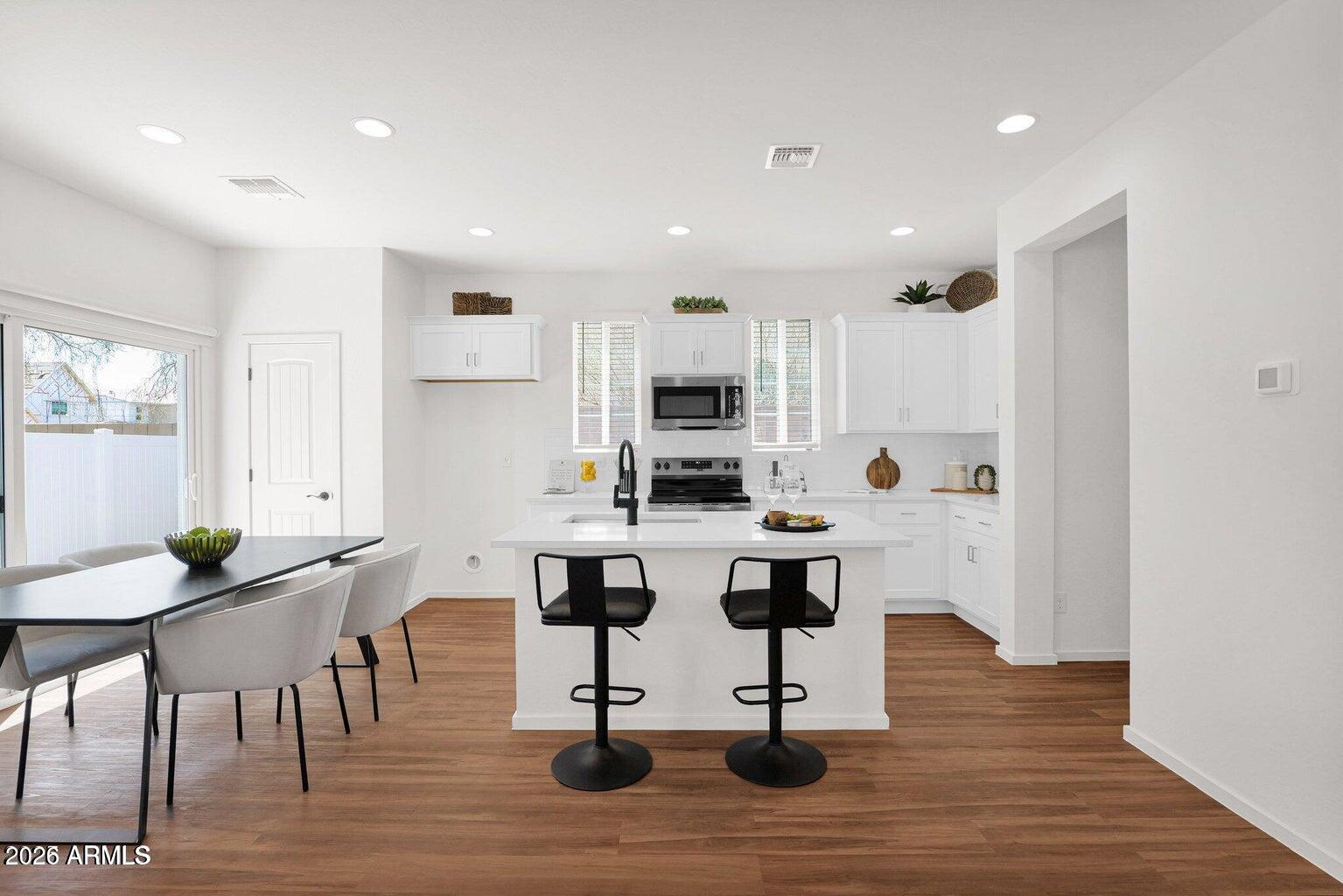 16874 North 12th Street, Unit 4 Phoenix, AZ 85022 - Photo 5 of 20 a view of kitchen with cabinets table and chairs