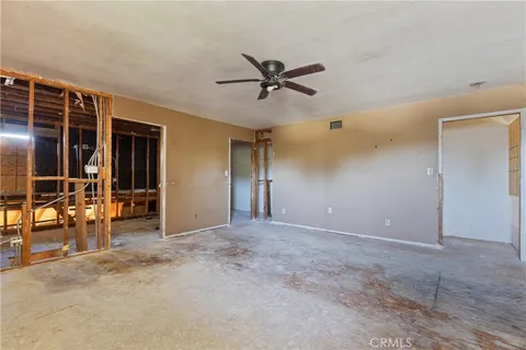 a view of a livingroom with a ceiling fan and window