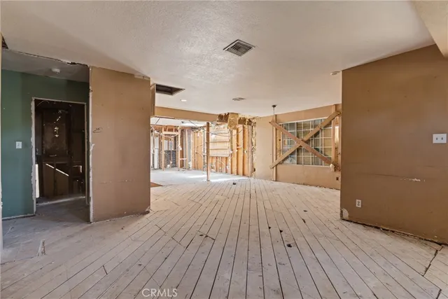 a view of an empty room and wooden floor