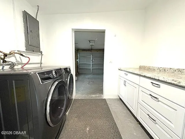 a view of a kitchen with washer and dryer