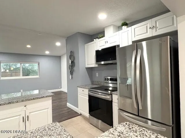 a kitchen with stainless steel appliances a refrigerator stove and sink