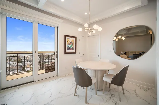 a view of a dining room with furniture and chandelier