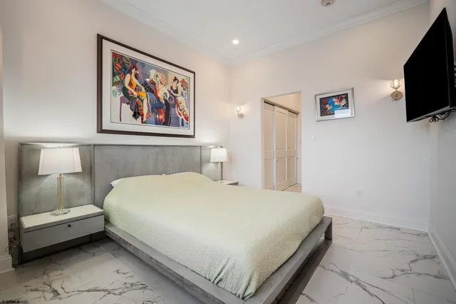 a bedroom with a bed and a flat screen tv