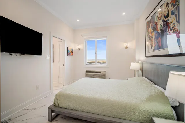 a bedroom with a bed and a flat screen tv