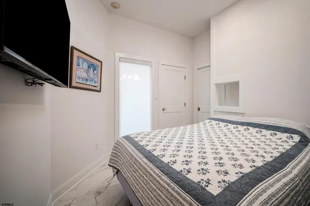 a bedroom with a bed and rug