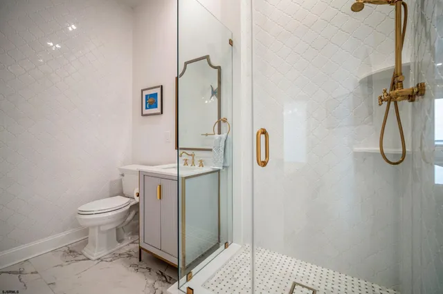 a bathroom with a shower toilet and sink