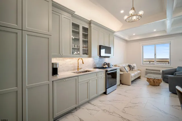 a kitchen with stainless steel appliances granite countertop a sink dishwasher stove and refrigerator with wooden floor