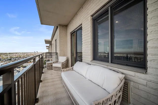 a balcony with table and chairs