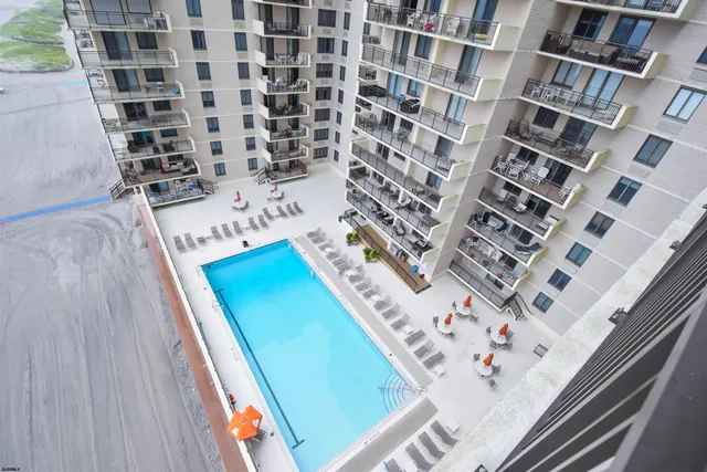 a view of a swimming pool and outdoor kitchen