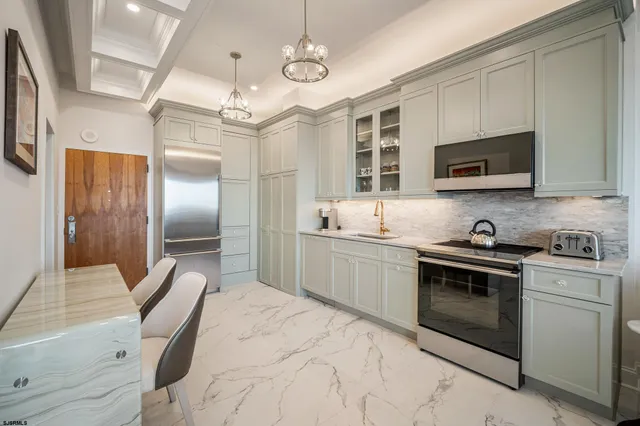 a kitchen with stainless steel appliances granite countertop a stove a sink and a refrigerator