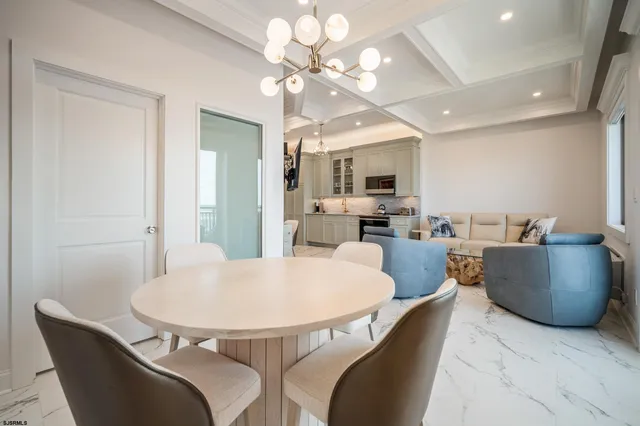 a dining room with furniture and a chandelier