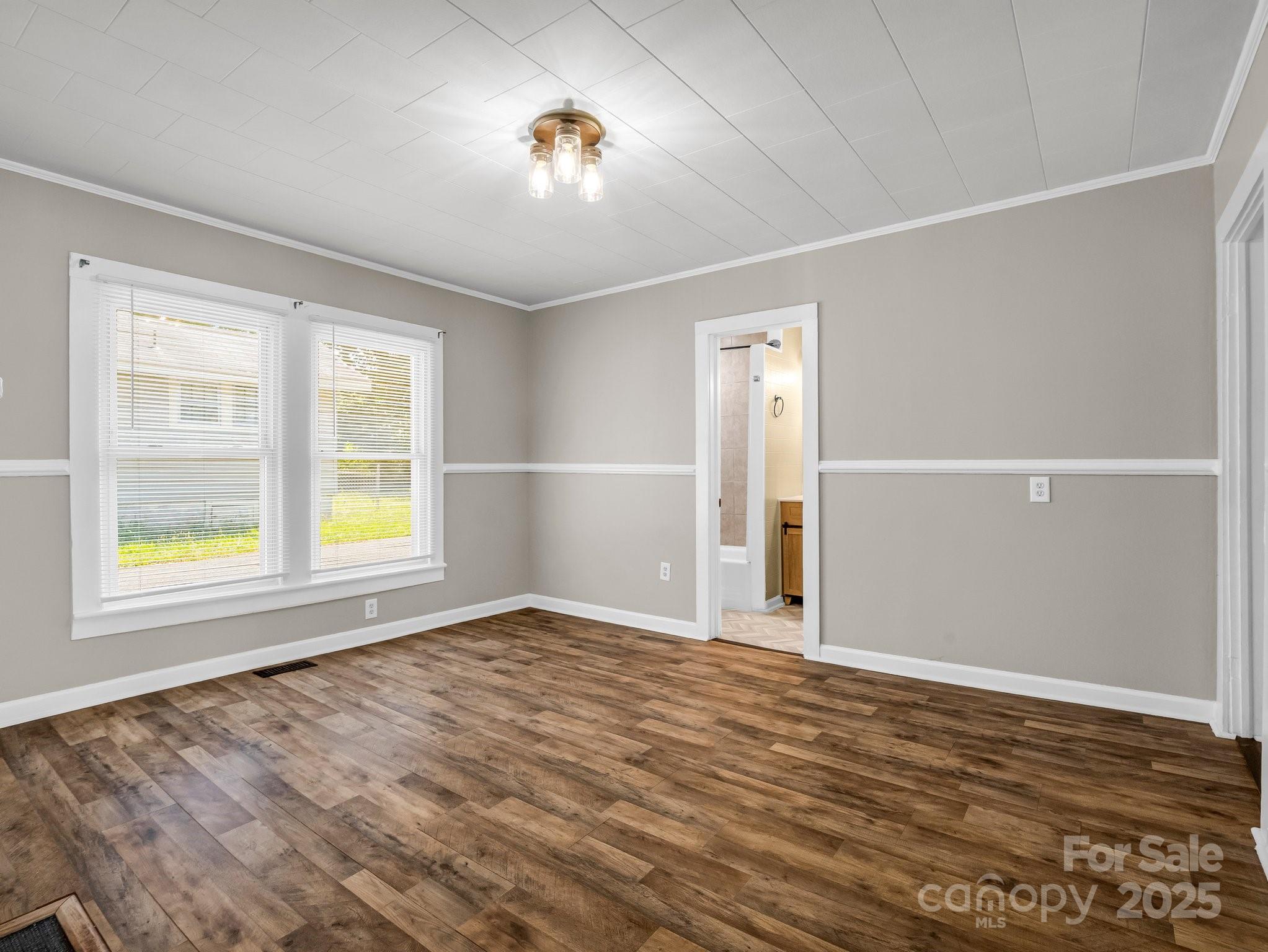 149 Wisconsin Street Spindale, NC 28160 - Photo 11 of 23 wooden floor in an empty room with a window