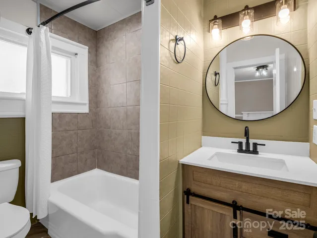 a bathroom with a sink a toilet and bathtub
