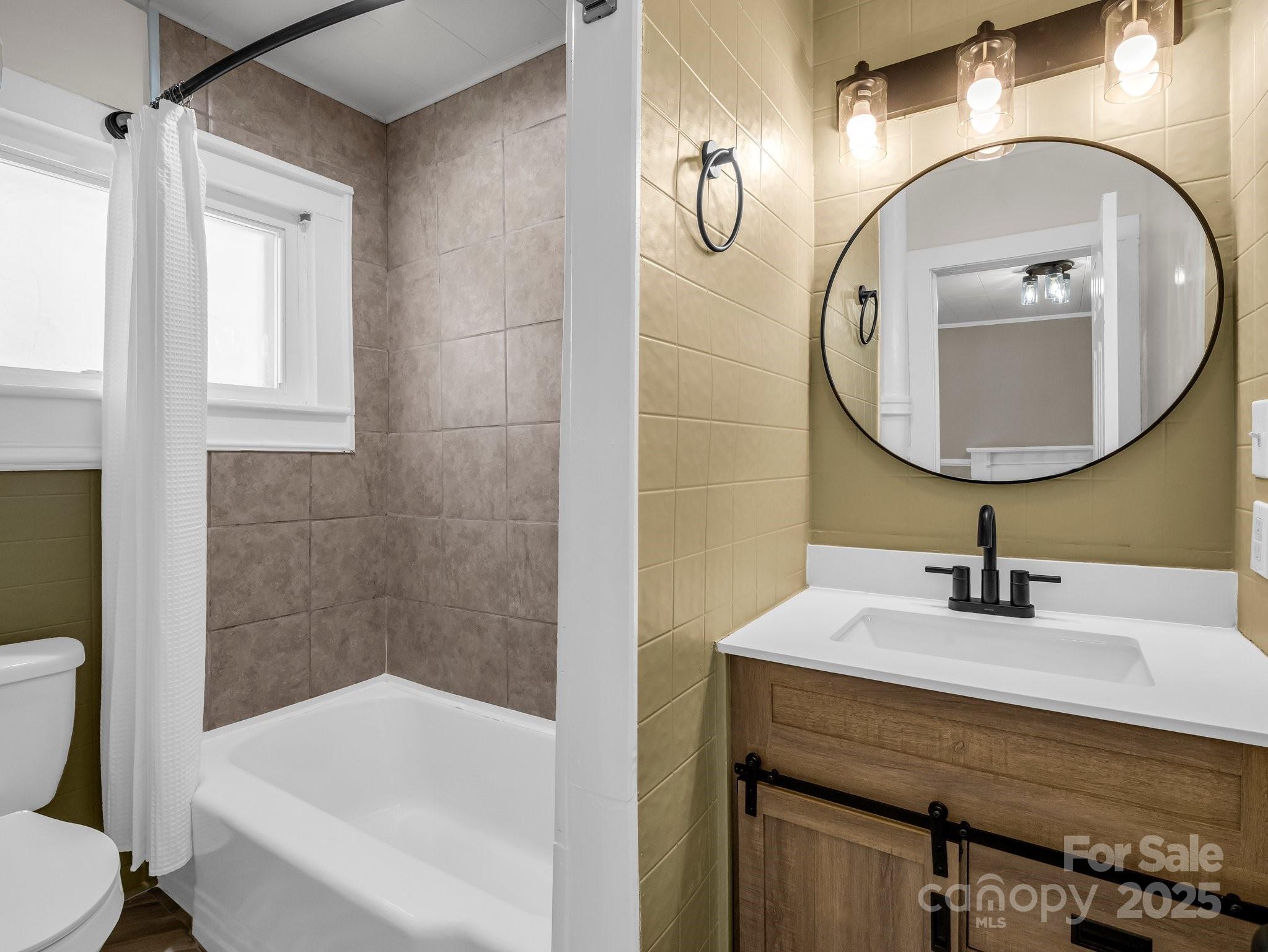 149 Wisconsin Street Spindale, NC 28160 - Photo 15 of 23 a bathroom with a sink a toilet and bathtub