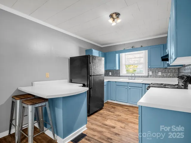 a kitchen with wooden cabinets and a stove top oven