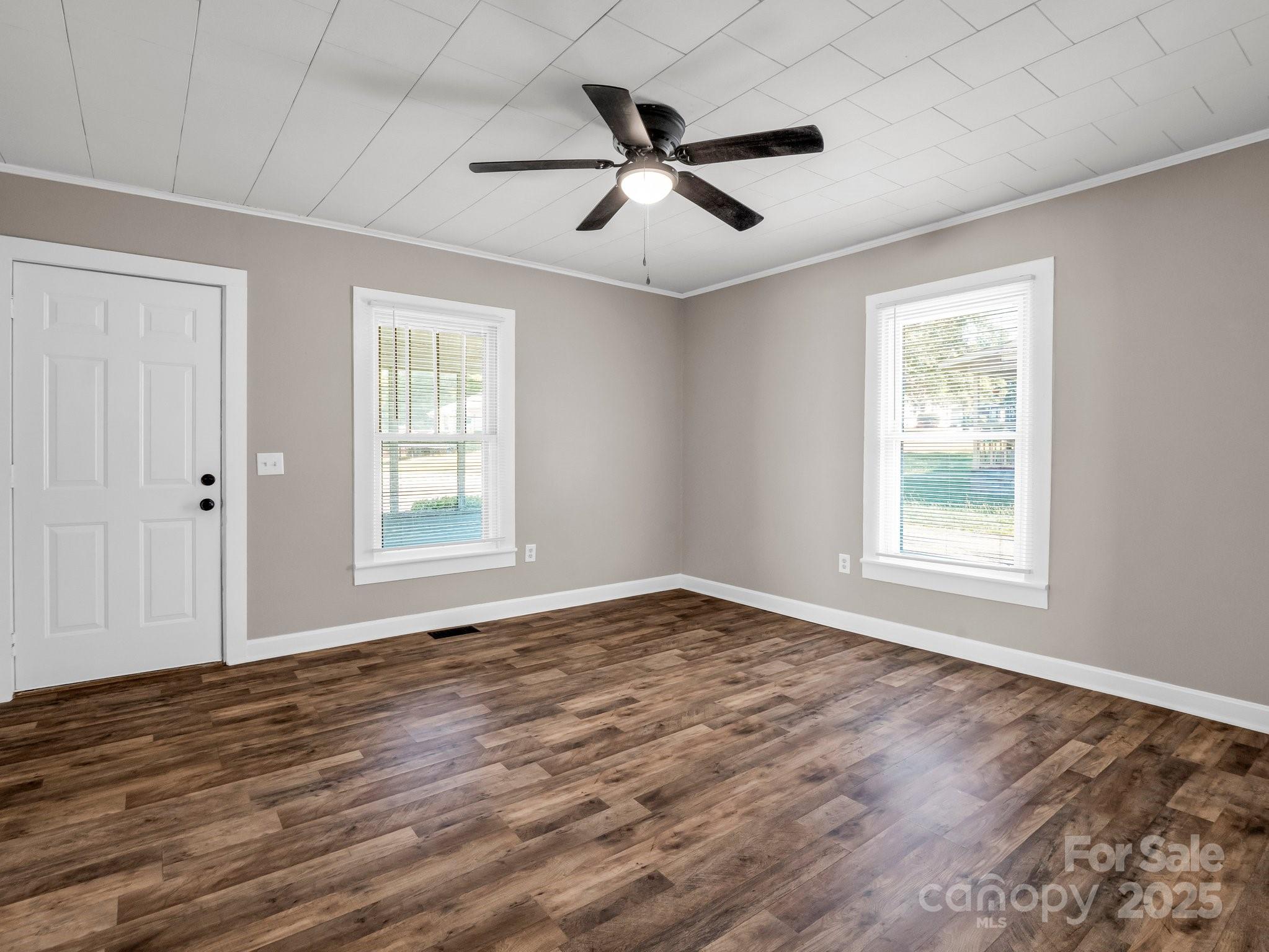 149 Wisconsin Street Spindale, NC 28160 - Photo 5 of 23 a view of empty room with wooden floor and fan